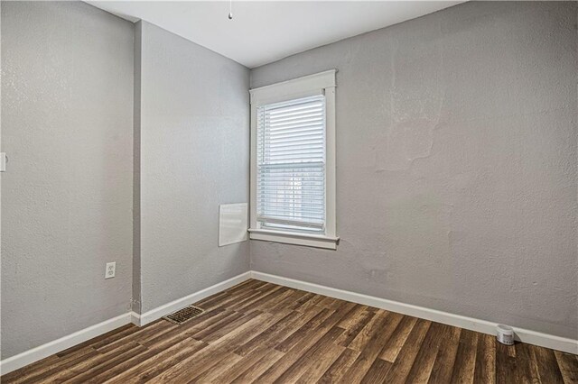 spare room featuring dark hardwood / wood-style floors