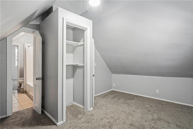 bonus room featuring lofted ceiling, ceiling fan, and light colored carpet