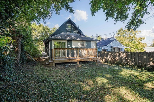 back of house with a lawn and a wooden deck