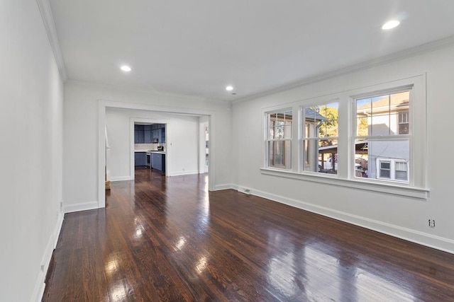 unfurnished living room with crown molding and dark hardwood / wood-style flooring