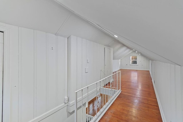 additional living space featuring lofted ceiling and hardwood / wood-style flooring