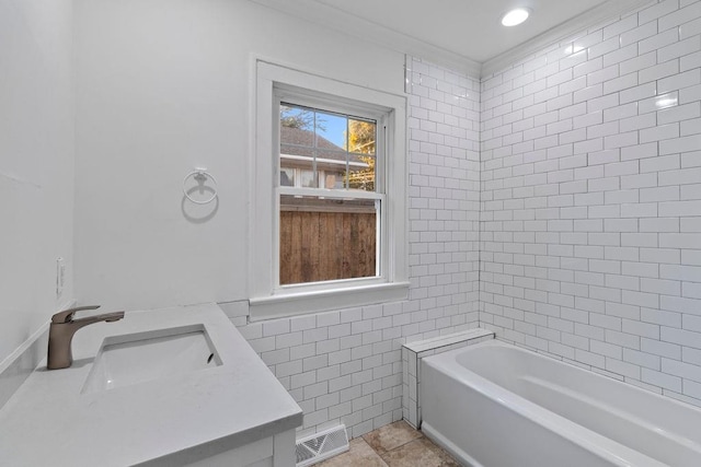 bathroom with vanity, tile patterned floors, tiled shower / bath combo, and tile walls