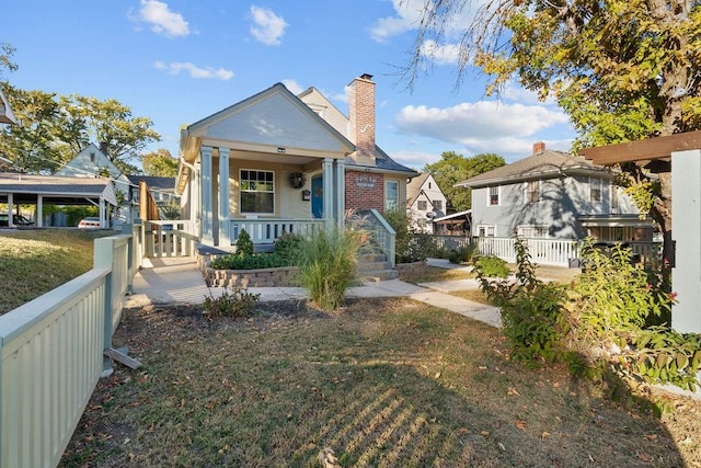 bungalow-style home with a porch and a front yard