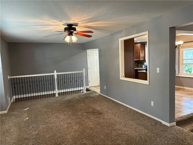 spare room with ceiling fan and carpet flooring