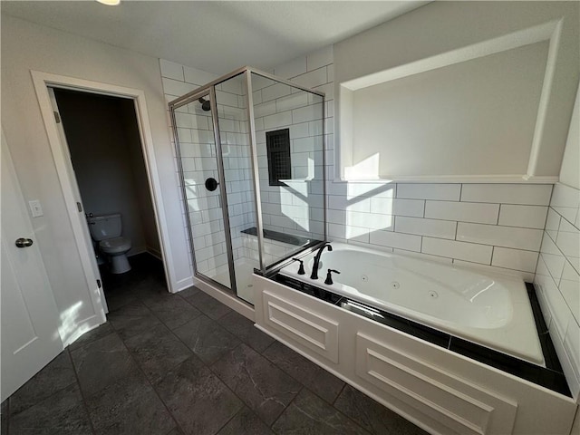 full bathroom featuring a stall shower, a tub with jets, toilet, and baseboards