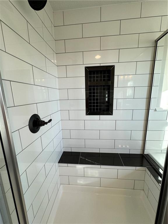 bathroom with tiled shower