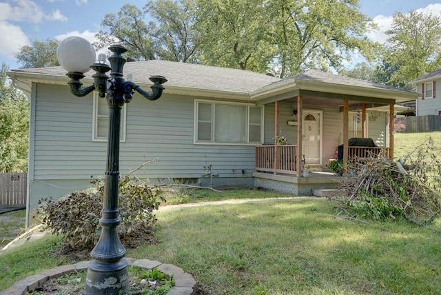 view of front of property featuring covered porch and a front yard