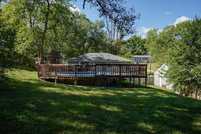 view of yard with a swimming pool side deck