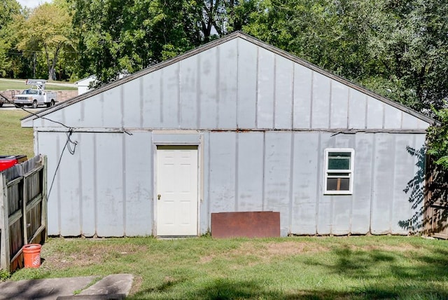 view of outdoor structure featuring a lawn