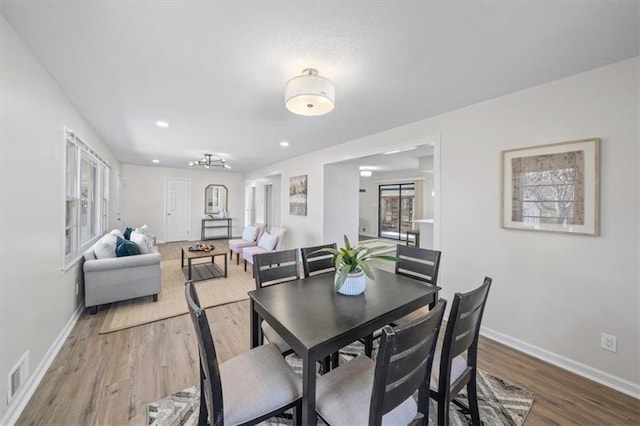 dining area with hardwood / wood-style flooring and plenty of natural light