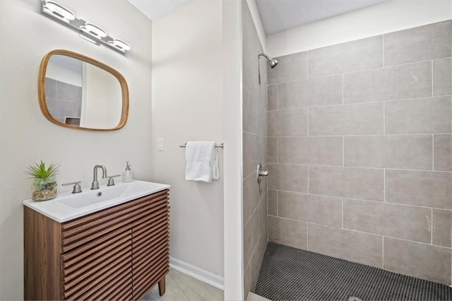 bathroom featuring vanity and tiled shower