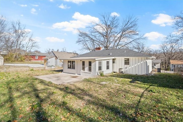 rear view of house with a yard and a patio