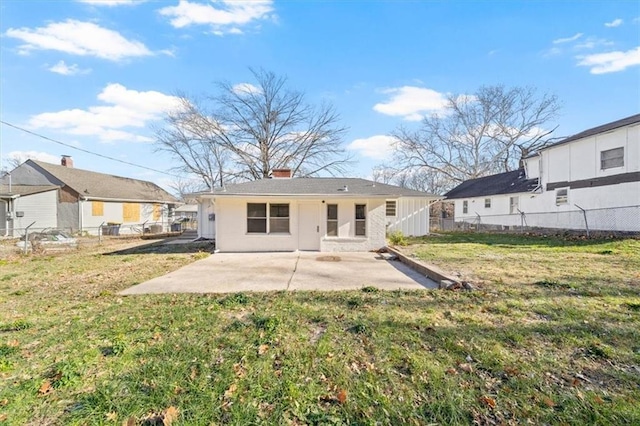 rear view of house with a patio area and a yard