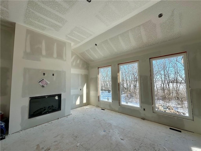 unfurnished living room with a glass covered fireplace