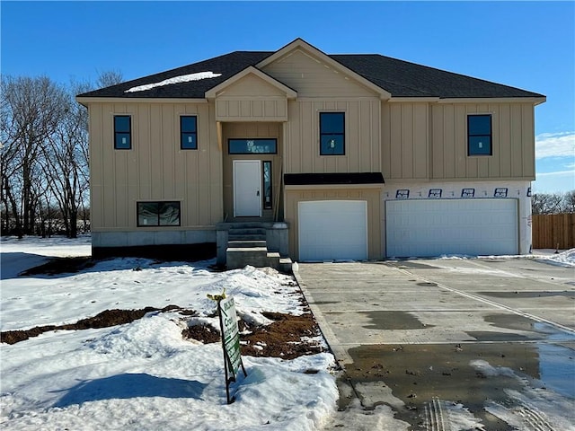 view of front of property featuring a garage, driveway, board and batten siding, and roof with shingles