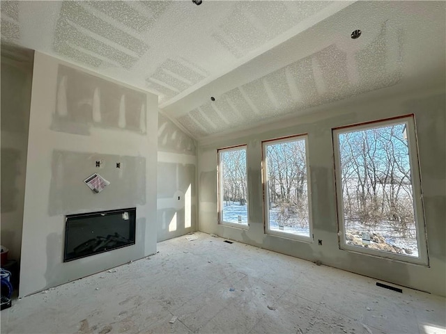 unfurnished living room with vaulted ceiling