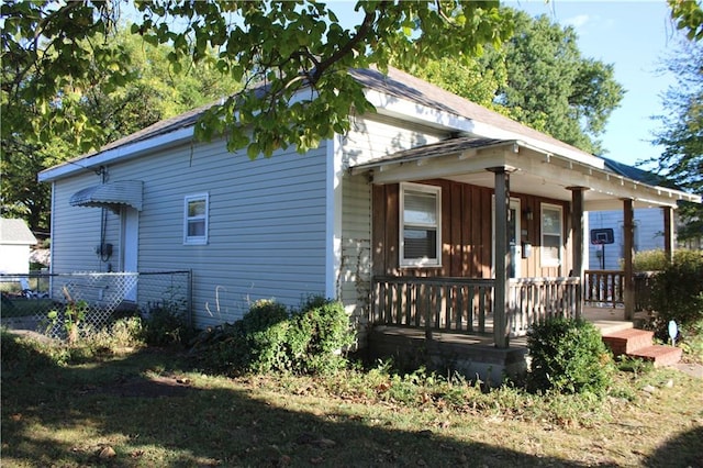 back of house featuring a porch