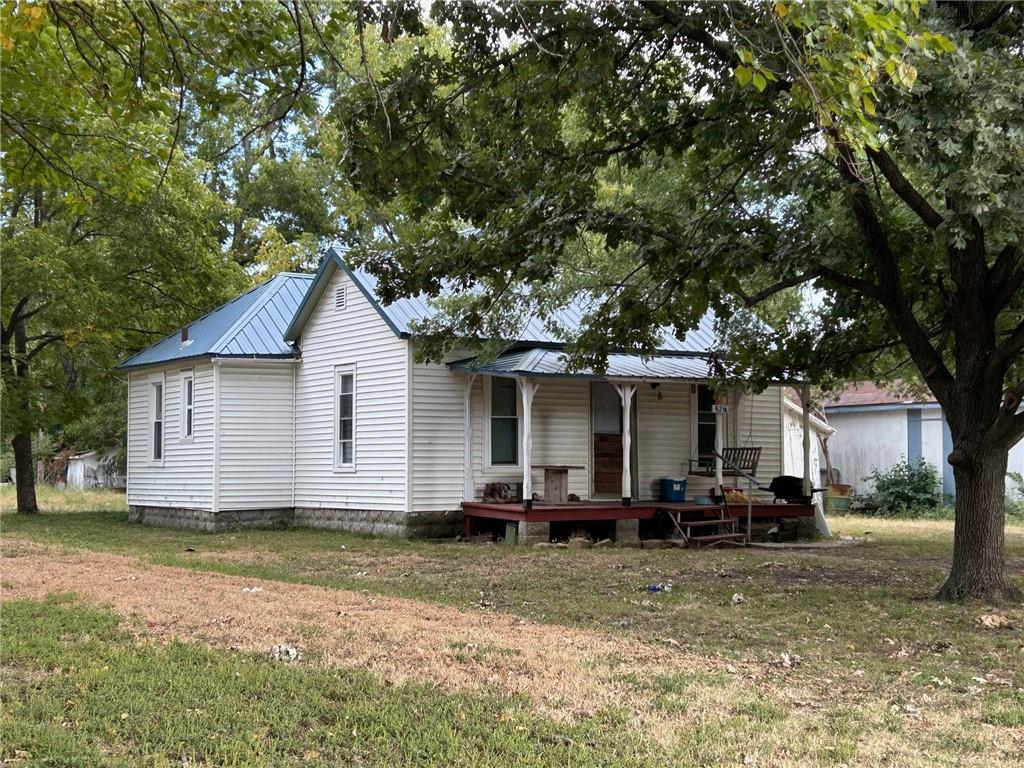 rear view of property featuring a yard