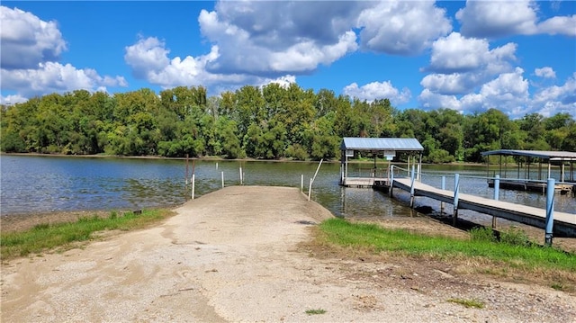 28530 Shore Rd, Warsaw, MO 65355 - dock featuring a water view, boat lift, and a view of trees