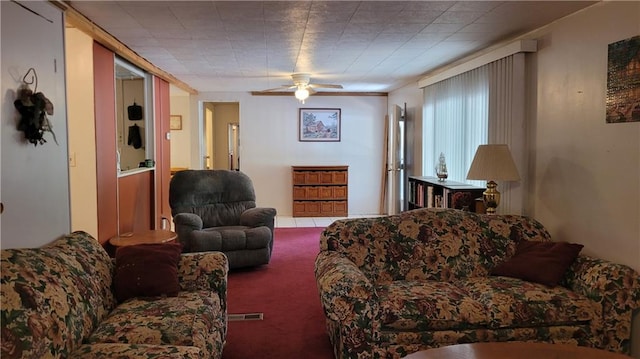 living room featuring carpet and ceiling fan