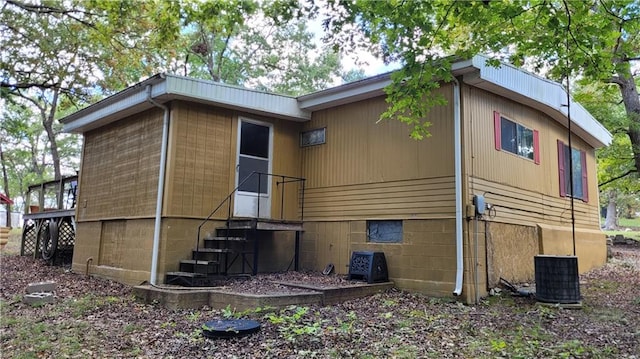 back of property featuring central AC