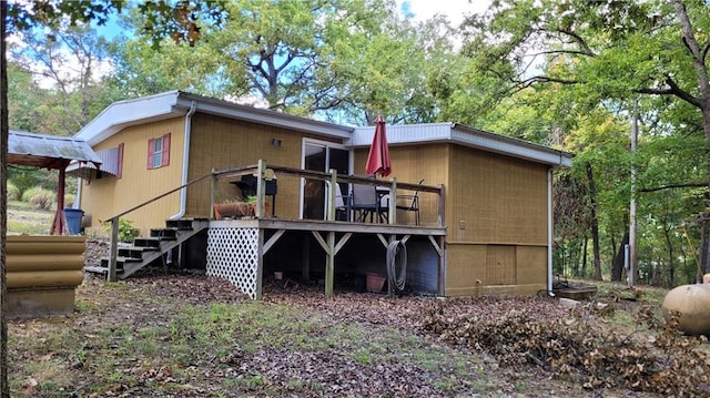 rear view of property with a wooden deck