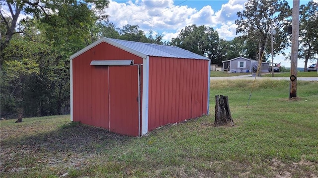 view of outbuilding with a yard