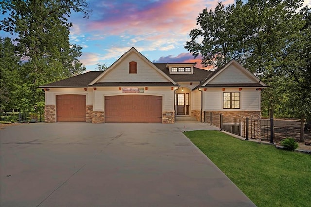 craftsman-style house with a lawn and a garage