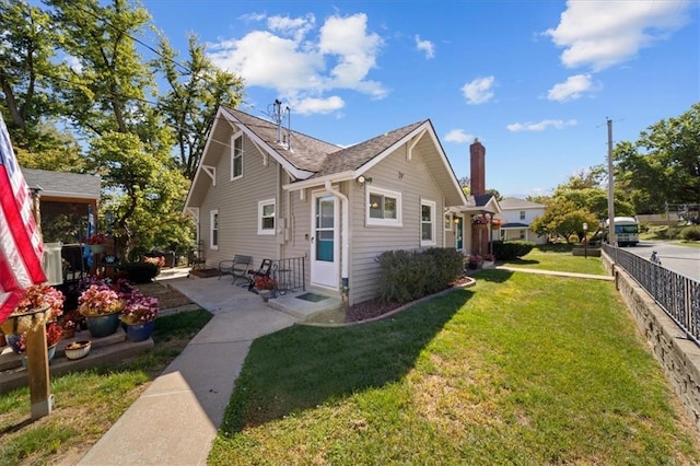 view of side of property with a yard