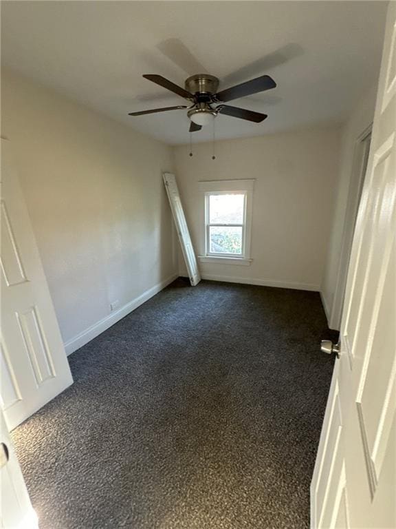 carpeted empty room featuring ceiling fan