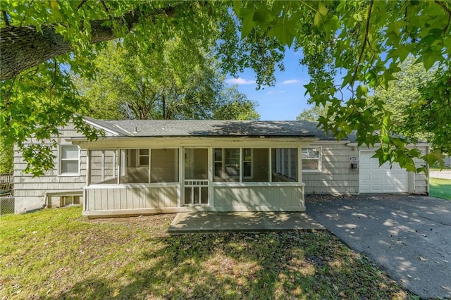 ranch-style home with a sunroom and a garage