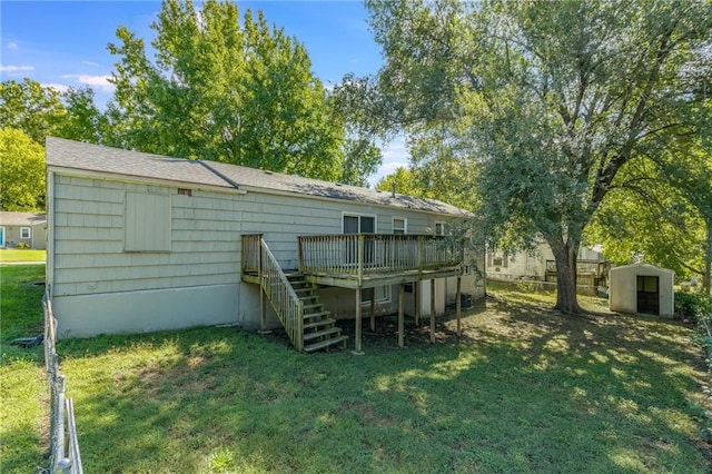 back of property featuring a shed, a deck, and a yard