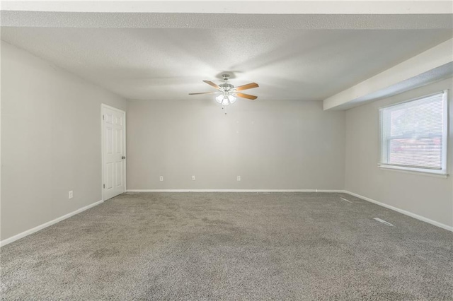 carpeted spare room with ceiling fan and a textured ceiling