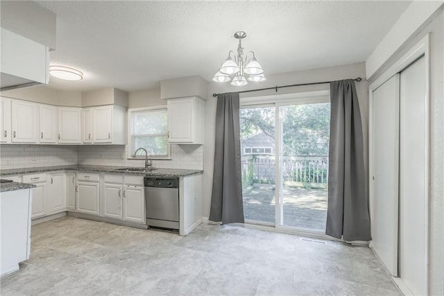 kitchen featuring a chandelier, sink, white cabinets, decorative backsplash, and stainless steel dishwasher