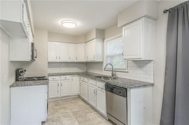 kitchen with appliances with stainless steel finishes, white cabinetry, sink, and stone countertops