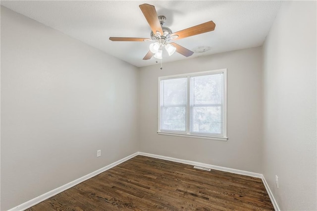 unfurnished room with ceiling fan and dark hardwood / wood-style flooring