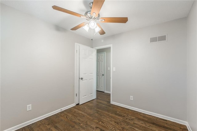 empty room featuring ceiling fan and dark hardwood / wood-style floors