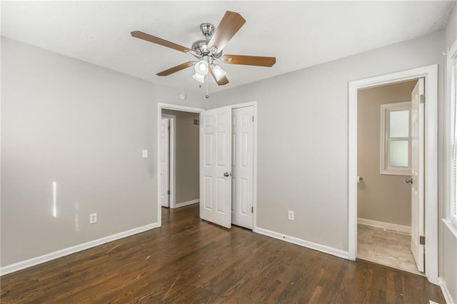 unfurnished bedroom featuring dark hardwood / wood-style floors and ceiling fan