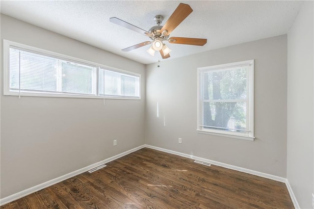 spare room featuring ceiling fan, a textured ceiling, and dark hardwood / wood-style flooring