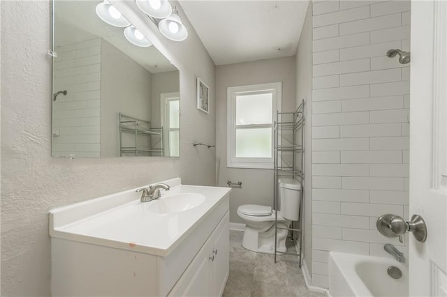 full bathroom featuring tiled shower / bath combo, vanity, and toilet