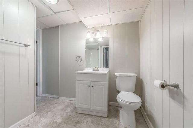 bathroom with vanity, a drop ceiling, and toilet