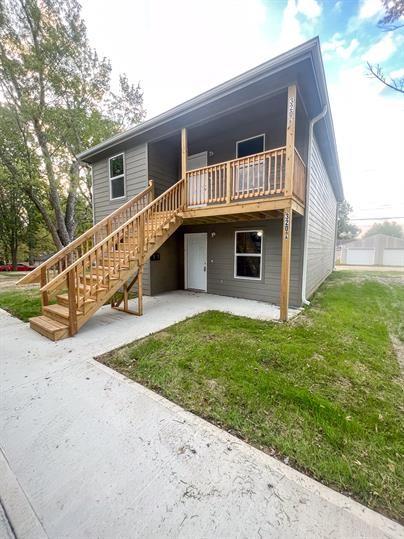 view of front of home with a front yard and a patio