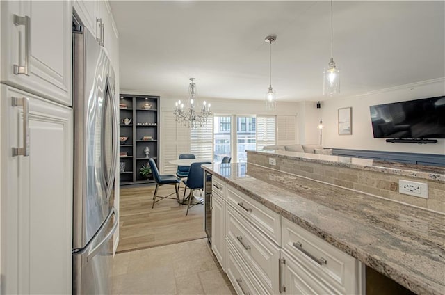 kitchen featuring stainless steel refrigerator, backsplash, pendant lighting, light hardwood / wood-style floors, and white cabinets