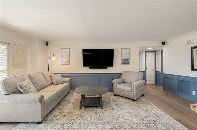 living room with light hardwood / wood-style floors and ornamental molding