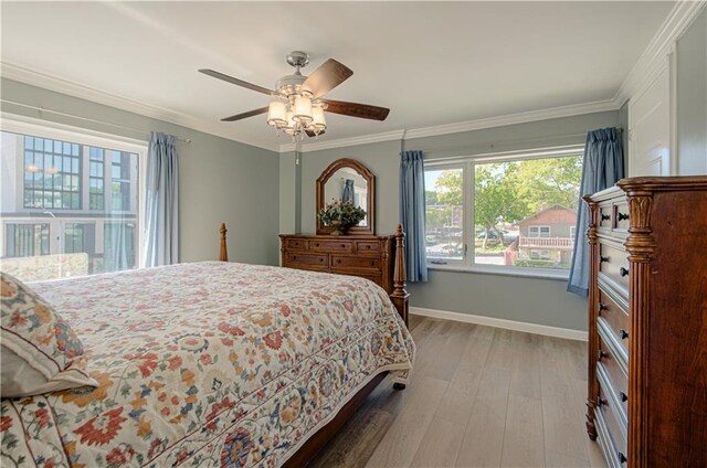 bedroom with ceiling fan, light hardwood / wood-style flooring, and crown molding