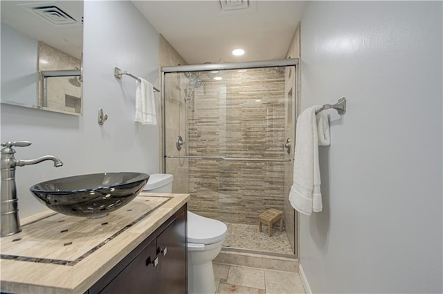 bathroom featuring toilet, an enclosed shower, and vanity