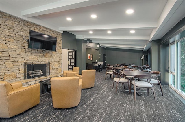 interior space with plenty of natural light, beam ceiling, and a fireplace