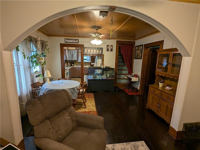 dining space featuring dark hardwood / wood-style flooring, ceiling fan, and crown molding