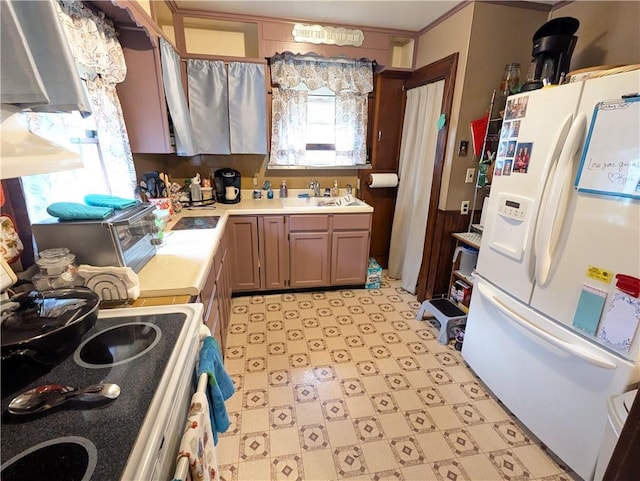 kitchen featuring white appliances and sink