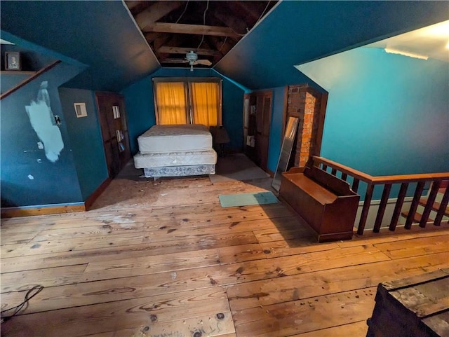 bedroom with hardwood / wood-style flooring and lofted ceiling